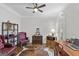 Office area with hardwood floors, burgundy leather chairs, and a cowhide rug under a ceiling fan at 107 Calloway Xing, Peachtree City, GA 30269