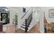 Staircase featuring hardwood flooring, white trim, and black banisters leading upstairs at 107 Calloway Xing, Peachtree City, GA 30269