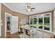 Sun-drenched living area with a view of the backyard, cozy seating, and a doorway to an adjacent bedroom at 107 Calloway Xing, Peachtree City, GA 30269