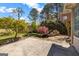 Landscaped backyard features a stone waterfall and mature trees at 269 Legends Trce, Mcdonough, GA 30253