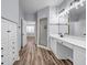 Bathroom featuring dual vanity, soaking tub, walk-in shower, and wood-look laminate flooring at 269 Legends Trce, Mcdonough, GA 30253