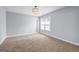 A bright room with built-in shelves, neutral carpet and large window at 269 Legends Trce, Mcdonough, GA 30253
