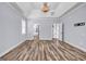 Bedroom featuring wood-look floors, modern trim, and access to an en-suite bathroom and walk-in closet at 269 Legends Trce, Mcdonough, GA 30253