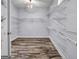 Walk-in closet with wood-look laminate flooring and wire shelving at 269 Legends Trce, Mcdonough, GA 30253