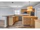 Kitchen featuring wood cabinets, stainless steel appliances, laminate countertops, and a center island at 269 Legends Trce, Mcdonough, GA 30253