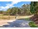 Community playground area with swings and mature trees at 269 Legends Trce, Mcdonough, GA 30253