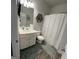 Cozy full bathroom has shower/tub combo, a vanity and decorative shelving at 5257 Shorthorn Way, Powder Springs, GA 30127