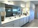 Bathroom featuring double sinks, plenty of counter space, and a large mirror at 5257 Shorthorn Way, Powder Springs, GA 30127