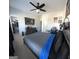 Bedroom featuring carpeted floors, a ceiling fan, TV, and a walk-in closet at 5257 Shorthorn Way, Powder Springs, GA 30127