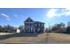 Charming two-story home with manicured lawn, and brick and siding facade under a bright, sunny sky at 5257 Shorthorn Way, Powder Springs, GA 30127