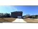 View of the home's driveway and garage from the street at 5257 Shorthorn Way, Powder Springs, GA 30127