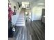 Bright foyer with hardwood floors, staircase, and decorative wall art; a welcoming entry space at 5257 Shorthorn Way, Powder Springs, GA 30127