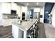 Spacious kitchen with a large island, granite counters, stainless appliances, and ample seating at 5257 Shorthorn Way, Powder Springs, GA 30127