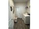 Convenient laundry room with washer, dryer, and overhead shelving at 5257 Shorthorn Way, Powder Springs, GA 30127