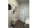 Well-organized laundry room features decorative signs and a wooden-style floor at 5257 Shorthorn Way, Powder Springs, GA 30127