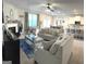Open living room features fireplace, ceiling fan and flows into kitchen and dining area at 5257 Shorthorn Way, Powder Springs, GA 30127