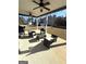 Relaxing outdoor patio seating area with ceiling fans and a grill at 5257 Shorthorn Way, Powder Springs, GA 30127