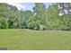 Expansive backyard featuring a shed, mature trees, and plenty of space at 260 Sharon Dr, Fayetteville, GA 30214