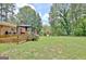 Expansive backyard featuring a deck with a gazebo, lush greenery, and a play structure at 260 Sharon Dr, Fayetteville, GA 30214