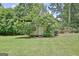 Backyard shed with fig trees, offering storage space and surrounded by greenery at 260 Sharon Dr, Fayetteville, GA 30214