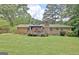 Beautiful brick home with lush landscaping and a cozy patio in the backyard at 260 Sharon Dr, Fayetteville, GA 30214