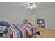 Comfortable bedroom featuring wood-look flooring, soft natural light, and a ceiling fan at 260 Sharon Dr, Fayetteville, GA 30214