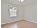 Cozy bedroom features wood flooring, a window, and natural light at 260 Sharon Dr, Fayetteville, GA 30214