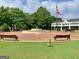 Lovely fountain area with manicured landscaping, benches, and a flagpole, creating a welcoming community space at 260 Sharon Dr, Fayetteville, GA 30214