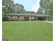 Charming brick home with a well-manicured front yard and covered parking at 260 Sharon Dr, Fayetteville, GA 30214