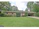 Charming brick home with a well-manicured front yard and covered parking at 260 Sharon Dr, Fayetteville, GA 30214