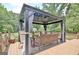 Cozy gazebo area with comfortable seating, decorative lighting, and a view of the lush greenery at 260 Sharon Dr, Fayetteville, GA 30214