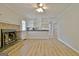 Bright living room features a brick fireplace and access to kitchen at 260 Sharon Dr, Fayetteville, GA 30214