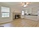 Bright living room features a brick fireplace and access to kitchen at 260 Sharon Dr, Fayetteville, GA 30214