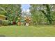 Backyard view of a well-maintained playground with swings and slides, perfect for Gathering fun at 260 Sharon Dr, Fayetteville, GA 30214
