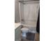 Standard bathroom features a toilet, shower-tub, and a neutral gray floor mat at 250 Jonesboro Rd, Jonesboro, GA 30236