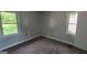 Cozy bedroom featuring gray walls, carpet and natural light from two windows at 250 Jonesboro Rd, Jonesboro, GA 30236