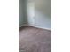 Bedroom featuring neutral carpet, gray walls, a window, and white baseboards at 250 Jonesboro Rd, Jonesboro, GA 30236