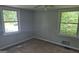 Cozy bedroom with two large windows offering ample natural light and neutral carpet at 250 Jonesboro Rd, Jonesboro, GA 30236