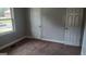 Bedroom features neutral carpet, gray walls, a window and two closets at 250 Jonesboro Rd, Jonesboro, GA 30236