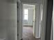 Hallway and bedroom with neutral walls and neutral carpeting that offers a seamless transition at 250 Jonesboro Rd, Jonesboro, GA 30236