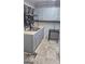 Functional kitchen featuring tile floors, neutral cabinets, and modern fixtures at 250 Jonesboro Rd, Jonesboro, GA 30236