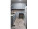 Traditional kitchen with stainless steel sink, gray cabinets, tiled backsplash, and refrigerator at 250 Jonesboro Rd, Jonesboro, GA 30236