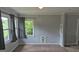 Sunlit living room featuring neutral walls, plush carpet, and ample natural light through large windows at 250 Jonesboro Rd, Jonesboro, GA 30236