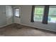 Bright living room with neutral walls, plush carpeting, and natural light from large windows at 250 Jonesboro Rd, Jonesboro, GA 30236