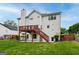Backyard with a lawn, fence, basement door, and elevated deck and stairs at 980 Charter Club, Lawrenceville, GA 30043