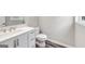 Bathroom vanity featuring a white countertop with neutral walls and wood-look floors at 980 Charter Club, Lawrenceville, GA 30043
