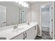 Bright bathroom featuring double sinks, a large mirror, and a shower/tub combo at 980 Charter Club, Lawrenceville, GA 30043