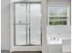 Modern bathroom with a glass enclosed shower and white garden tub and window at 980 Charter Club, Lawrenceville, GA 30043