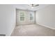 Bright bedroom featuring neutral walls, plush carpet, and two windows at 980 Charter Club, Lawrenceville, GA 30043