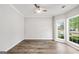 Bright bedroom featuring new floors and large windows overlooking the yard at 980 Charter Club, Lawrenceville, GA 30043
